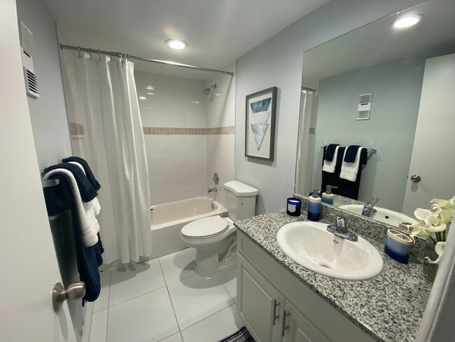 Granite Countertops with Modern, White Plywood Cabinetry With Self-Closing Hinges, in select units