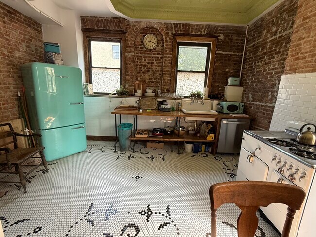 Kitchen (north end) with retro (functioning amenities) - 373 Decatur St Unit Sunny Retro Bed-Stuy Loft