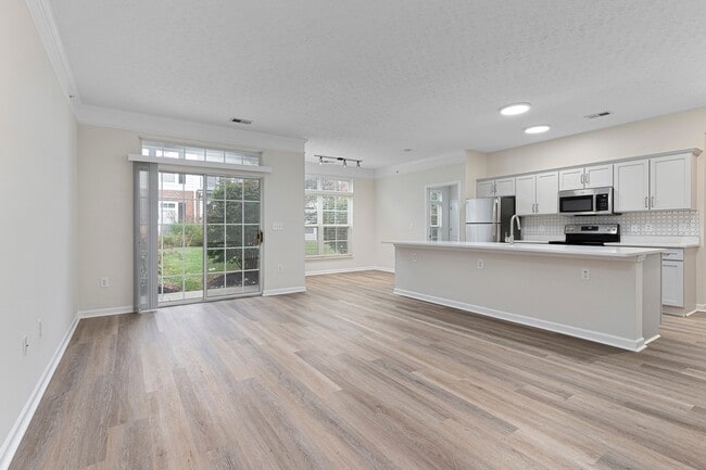 The Charleston Magnolia Premium Renovated with open concept Living, Kitchen and Dining area with wood style plank flooring