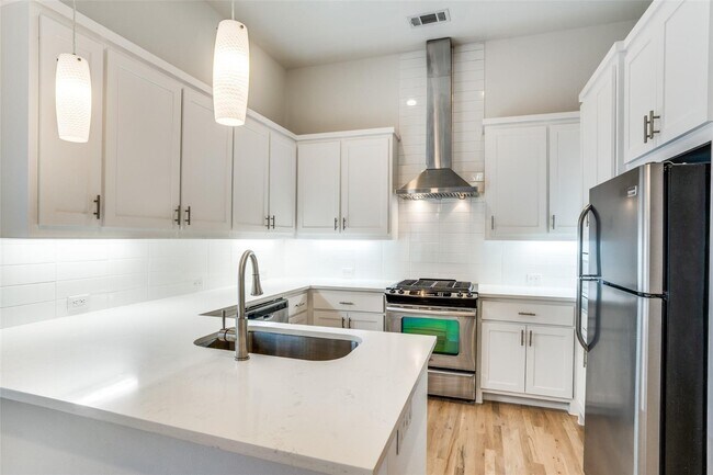 Photo - Beautiful townhome featuring granite countertops, hard wood floors, and a small private yard grea...