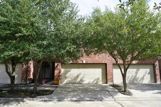 Large trees provide shade to the front of the house with an attached garage for parking. - 5230 Brinkman Ct