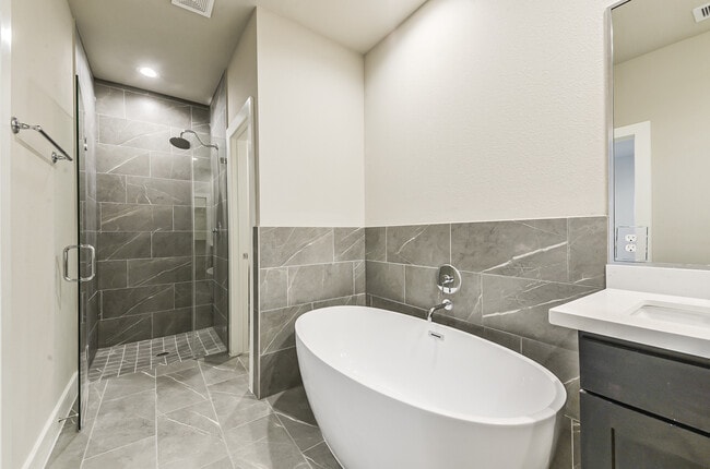 Spectacular master bath has tub and separate walk in shower and his and her vanities - 1108 Olivier Ln
