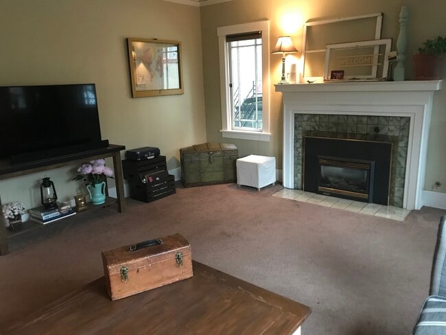 Living room with gas fireplace. - 1827 NE 11th Ave