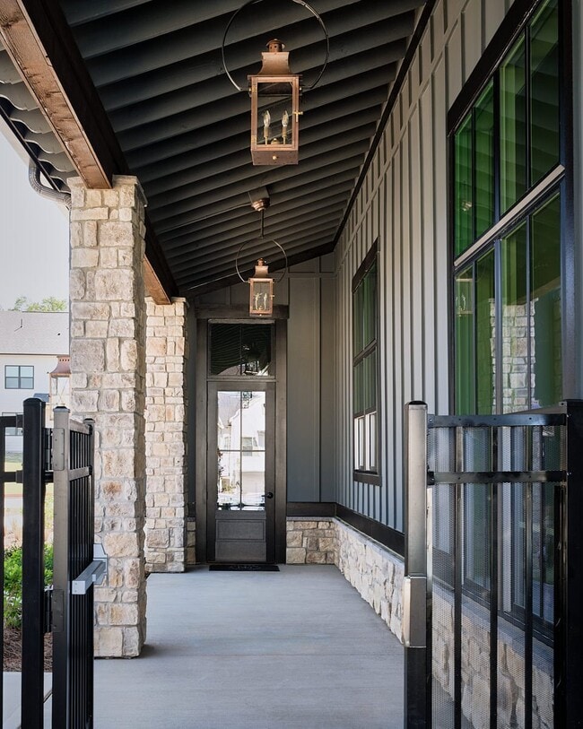Front porch of the Clubhouse featuring a black ceiling and inviting entryway. - The Bend at Pettit Creek