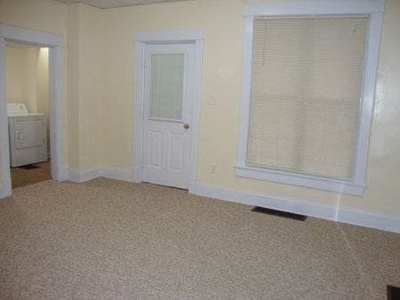 Living room looking at front door. Laundry room on left. - 522 E Market St Unit 522
