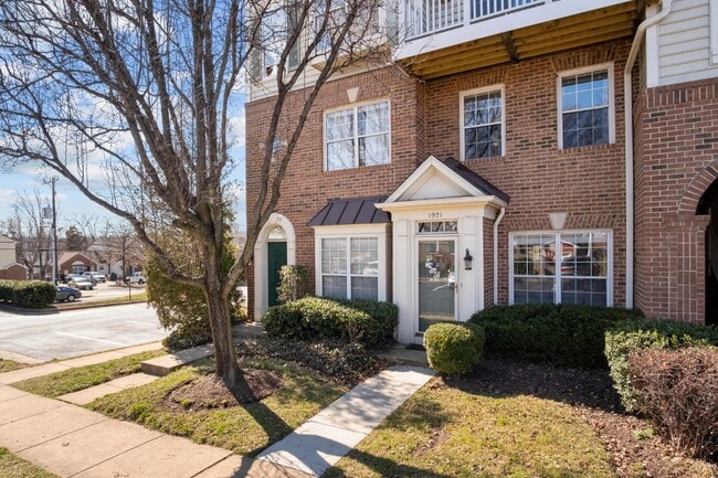 Building Photo - This inviting two-level townhome offers comfort and style, featuring gleaming hardwood floors on ...
