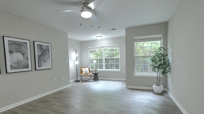 Spacious living room with a dedicated area for an at-home office or a reading nook. - The Grays at Old Town