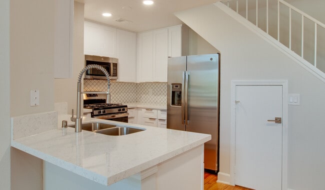 Spacious kitchens with wood flooring throughout