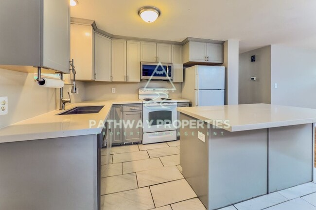 Photo - Charming 3-Bed, 1.5-Bath Brick Home with Spacious Living & Outdoor Retreat in Clearfield, UT!