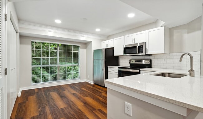 Large kitchen with stainless steel appliances, breakfast bar and great natural lighting