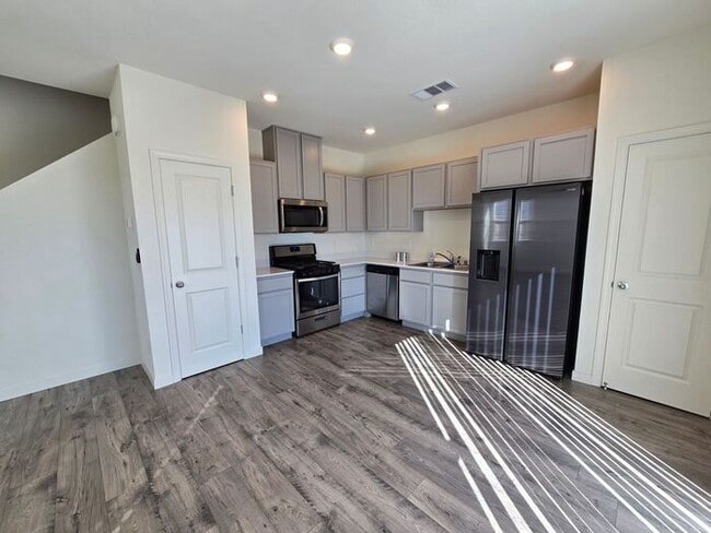Photo - Modern 3-Bedroom Townhome with 2-Car Garage, Bright Interiors & Private Patio