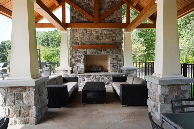 Outdoor resident lounge with fireplace - Toftrees