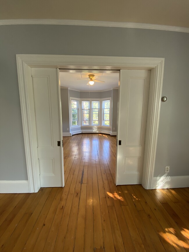 Front parlor/living room with pocket doors slightly closed - 86 Holden St Apartments Unit 2