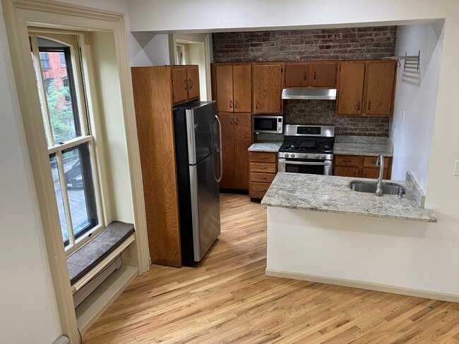 Kitchen with gas stove,microwave,fridge & dish washer - 143 Sussex St Unit Apt. #3