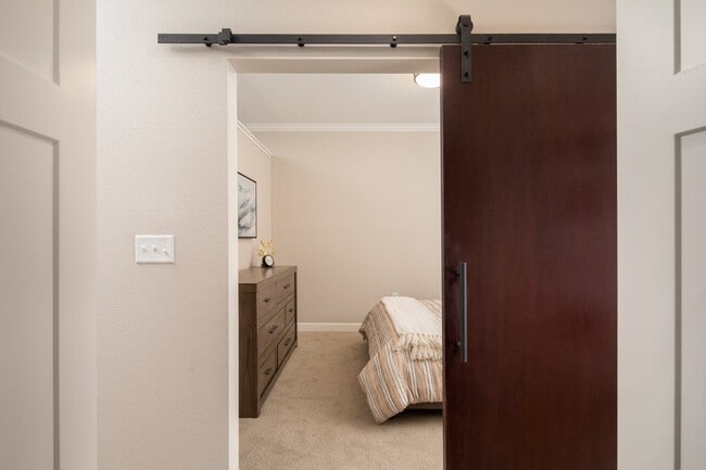 View of bedroom with modern sliding sliding door at The Whitley.