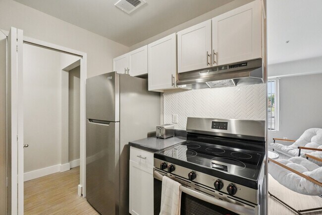 Cook with ease in kitchens featuring stainless steel refrigerator, dishwasher, and oven, professionally operated by Highlands Vista Group.