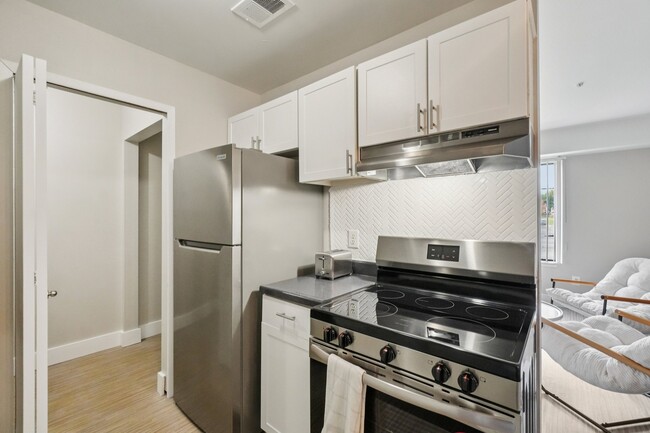 Cook with ease in kitchens featuring stainless steel refrigerator, dishwasher, and oven, professionally operated by Highlands Vista Group. - Bainbridge Park