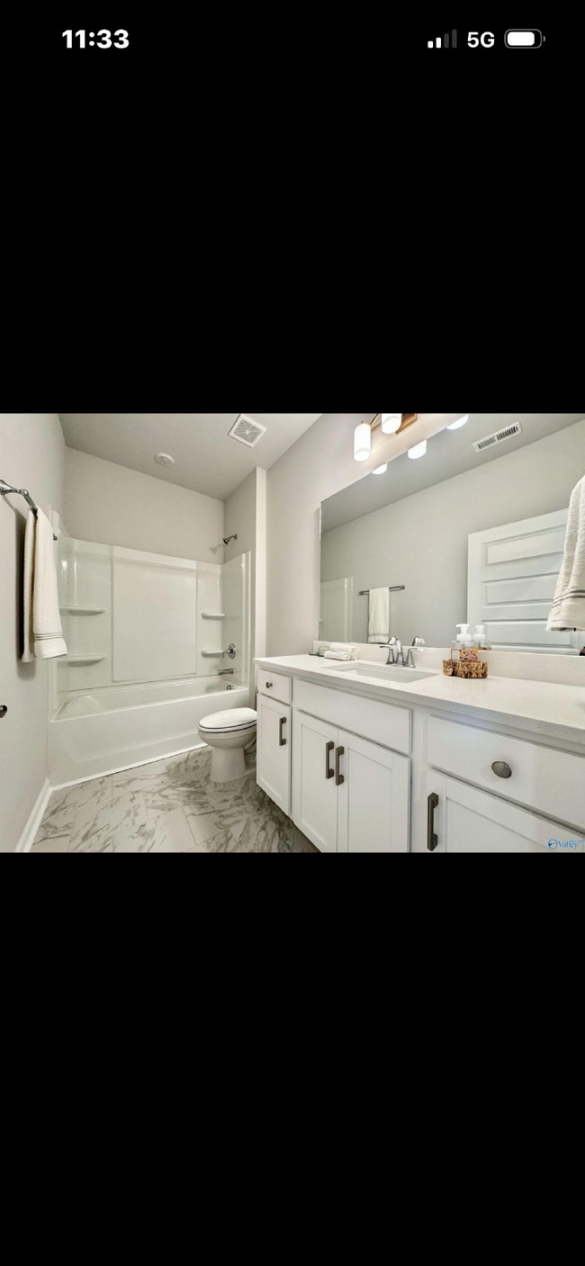 Photo - "NEWLY BUILT- Spacious 4-Bedroom Haven with Granite Elegance and Cozy Fireplace in Harvest"