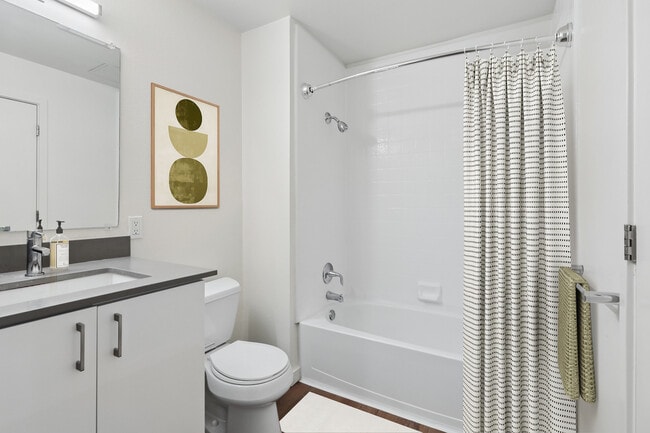 Classic Package II bath with white cabinetry, grey quartz countertops, and hard surface flooring