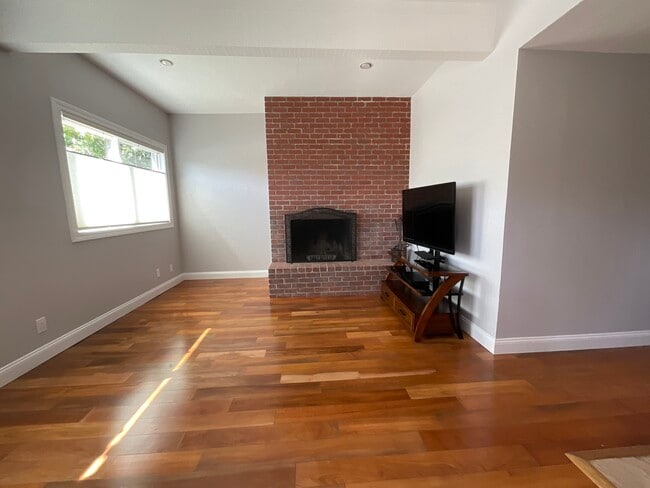 Living Room with large front windows and fireplace - 2452 Harding Ave Unit 2452A