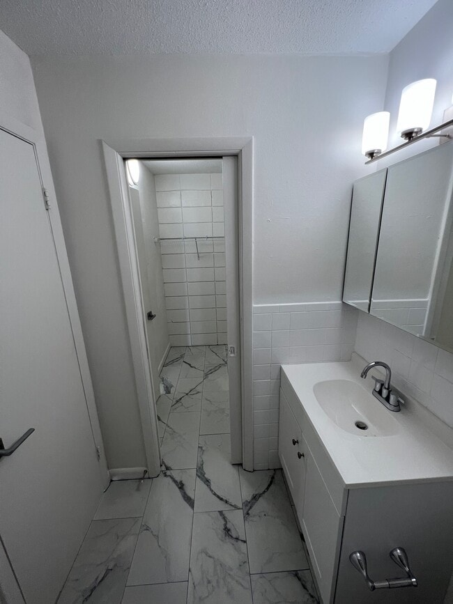 Bathroom looking into closet