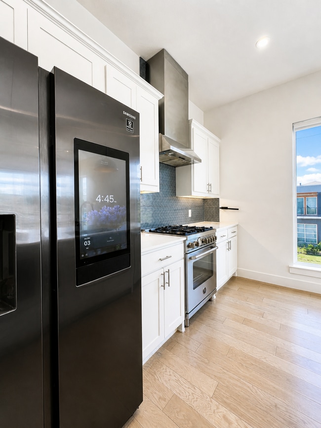 Kitchen with Samsung Smart fridge, Italian Stainless steel appliances and big windows - 5605 Bryan Pky Unit 101