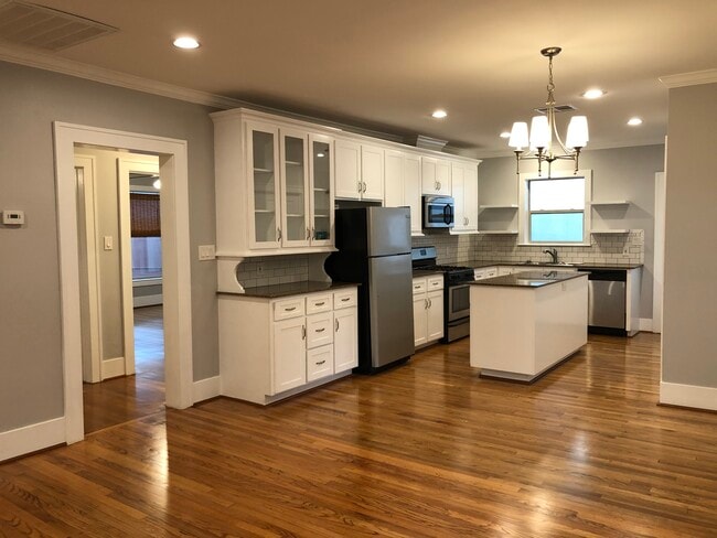 Large kitchen made for entertaining! Hallway shown to both bedrooms and bathroom - 1712 Blodgett St Unit #2