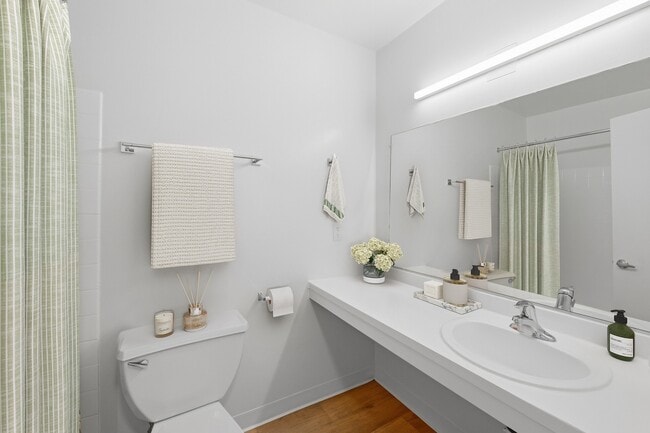 Step into elegance at Fairway Apartments. This modern bathroom boasts sleek designs, ample natural light, and stylish fixtures, creating a serene space for relaxation. Don't miss the chance to elevate your lifestyle—schedule your tour today!