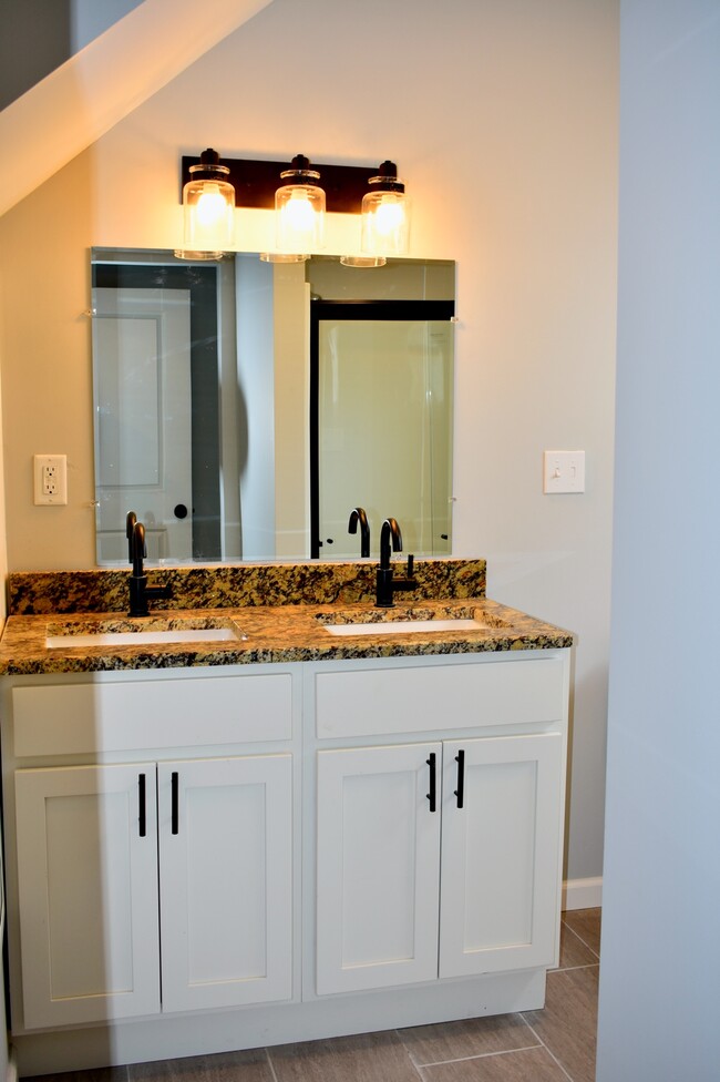 Bathroom with double vanity - 2416 West 10th Street Apartment Unit A