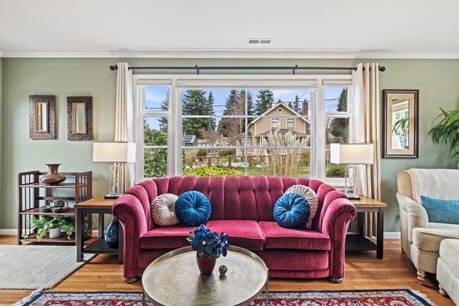 Sun-filled living room with peaceful neighborhood views. - 11639 1st Ave NW Unit 116391stAve