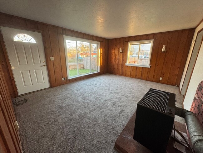 Photo - House with garage, carport, yard, & shed