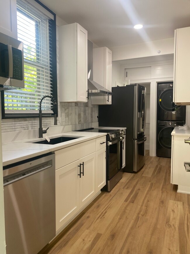 Full kitchen with in-unit laundry and coffee bar - 3409 Fernside Pl Apartments