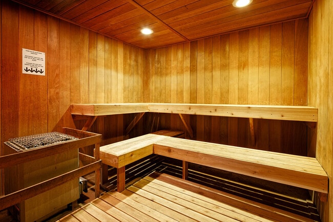 Experience the ultimate relaxation in this luxurious wooden sauna, designed for comfort and tranquility. - Timberline Place