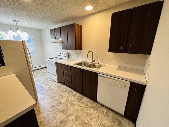 This galley kitchen features ample cabinet space, full-size appliances, and a practical layout for everyday cooking.