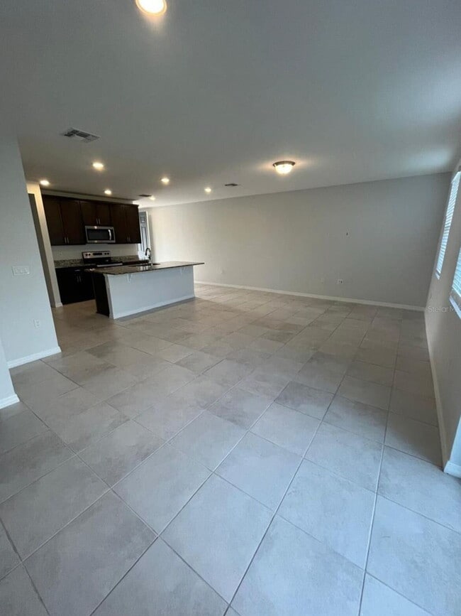 Photo - "Charming 3-Bed Townhouse with 2.5 Baths in St. Cloud's Serene Burrowing Owl Loop!"