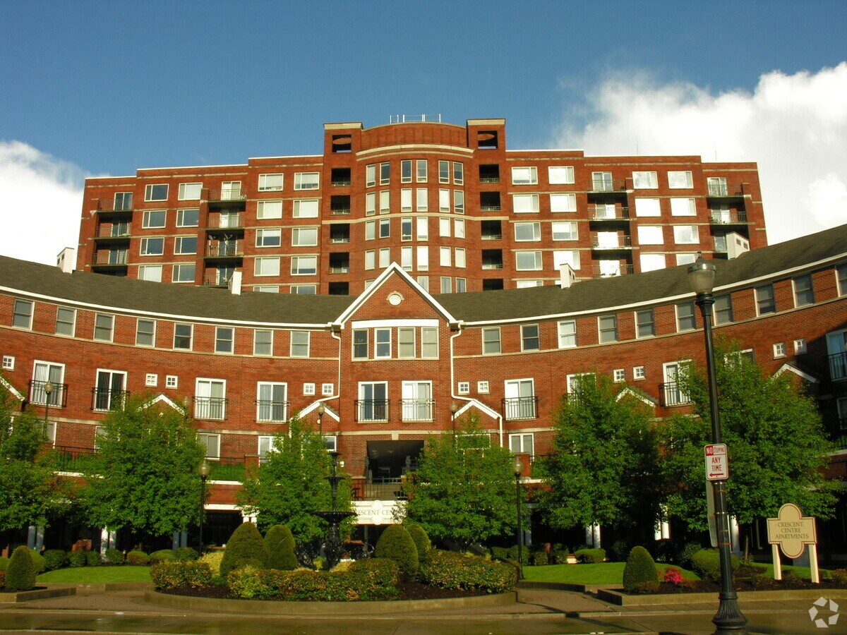 Looking up from Second Street at the townhouses and tower behind - Crescent Centre Tower Apartments