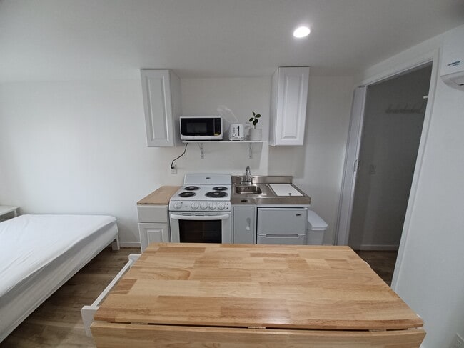Counter to left of stove: coming soon. - 3125 Curts Ave Unit Studio