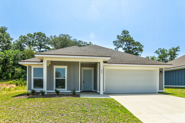 el frente de una casa con una entrada y una puerta de garaje - Cottages at Parkstone Homes