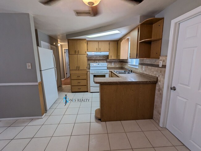 Photo - Must See 3/2/1 over 1000sf with tile/laminate floors, fresh paint, fenced yard and large living r...