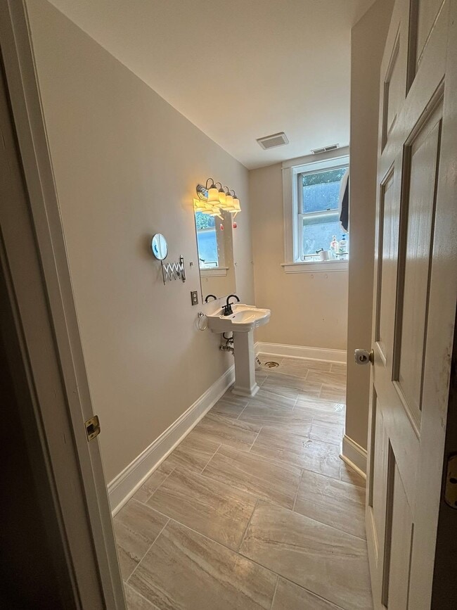 This the bathroom currently. There is a toilet the tile wasn’t dry yet. - 2056 Lafayette Ave Unit 2w