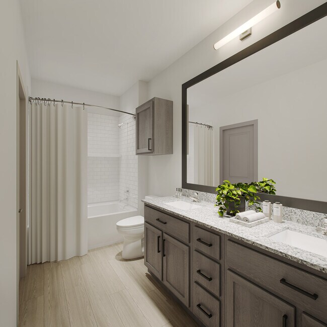 Modern Oakwood Trails bathroom with a large mirror, sleek vanity, and bright lighting for a fresh, contemporary look.