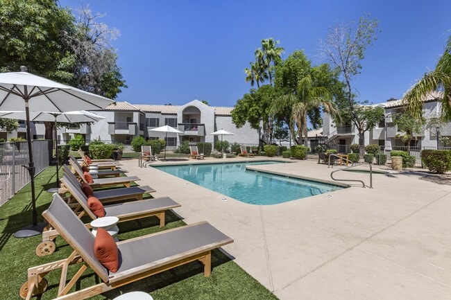Chic poolside retreat with lounge chairs and umbrellas, right outside our building