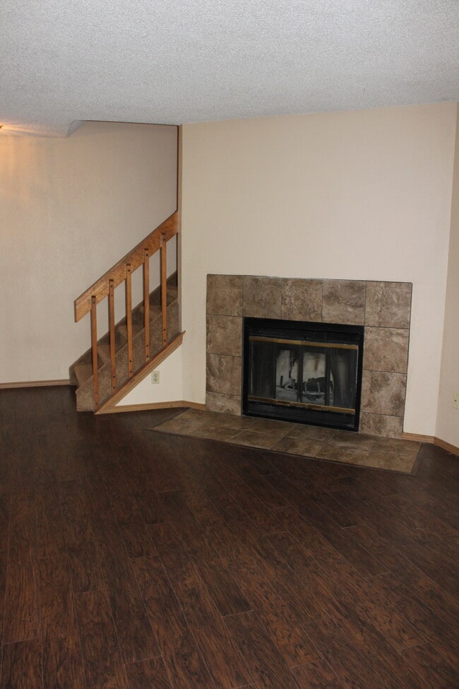 main living area with wood burning fireplace - 6469 McNichols Ct