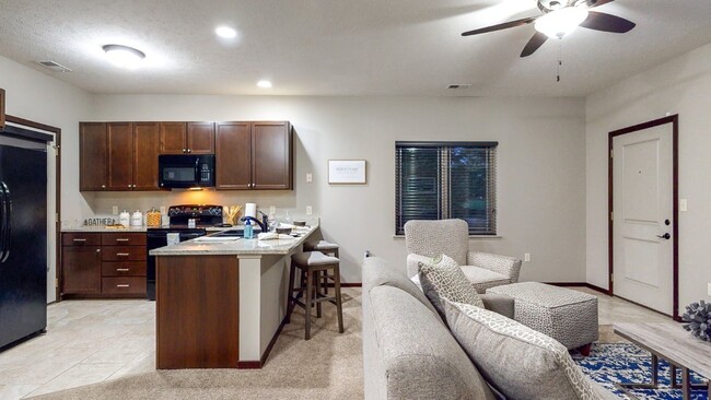 Open-concept layouts connect the kitchen and living areas, providing a seamless space to relax or gather. - The Villas at Wilderness Ridge Apartments