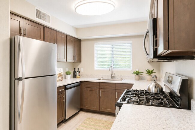 Step into the inviting kitchen at Falling Water, featuring modern appliances, sleek cabinetry, and abundant natural light. This space is perfect for culinary creativity and gatherings. Don’t miss the chance to elevate your living—schedule a tour today!