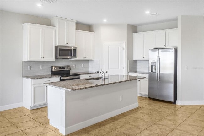 Photo - Open concept home offering four bedrooms, three baths, a two car garage and open lanai.