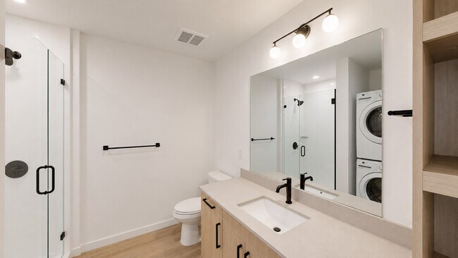 Modern minimalist bathroom with laundry area