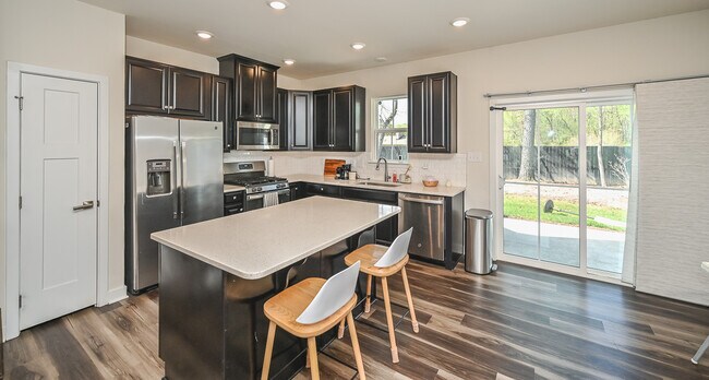 Modern kitchen with stainless steel appliances, granite countertops, and subway tile backsplash - 11313 Winding Brook Terrace Dr