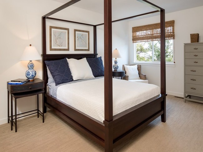 Phoenixville apartment bedroom with a canopy style bed, carpet, and large windows at Yardley Crossing