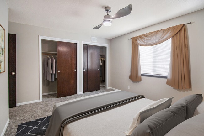 Welcoming Carpeted Bedroom with Closet in Pinehill Park Apartments